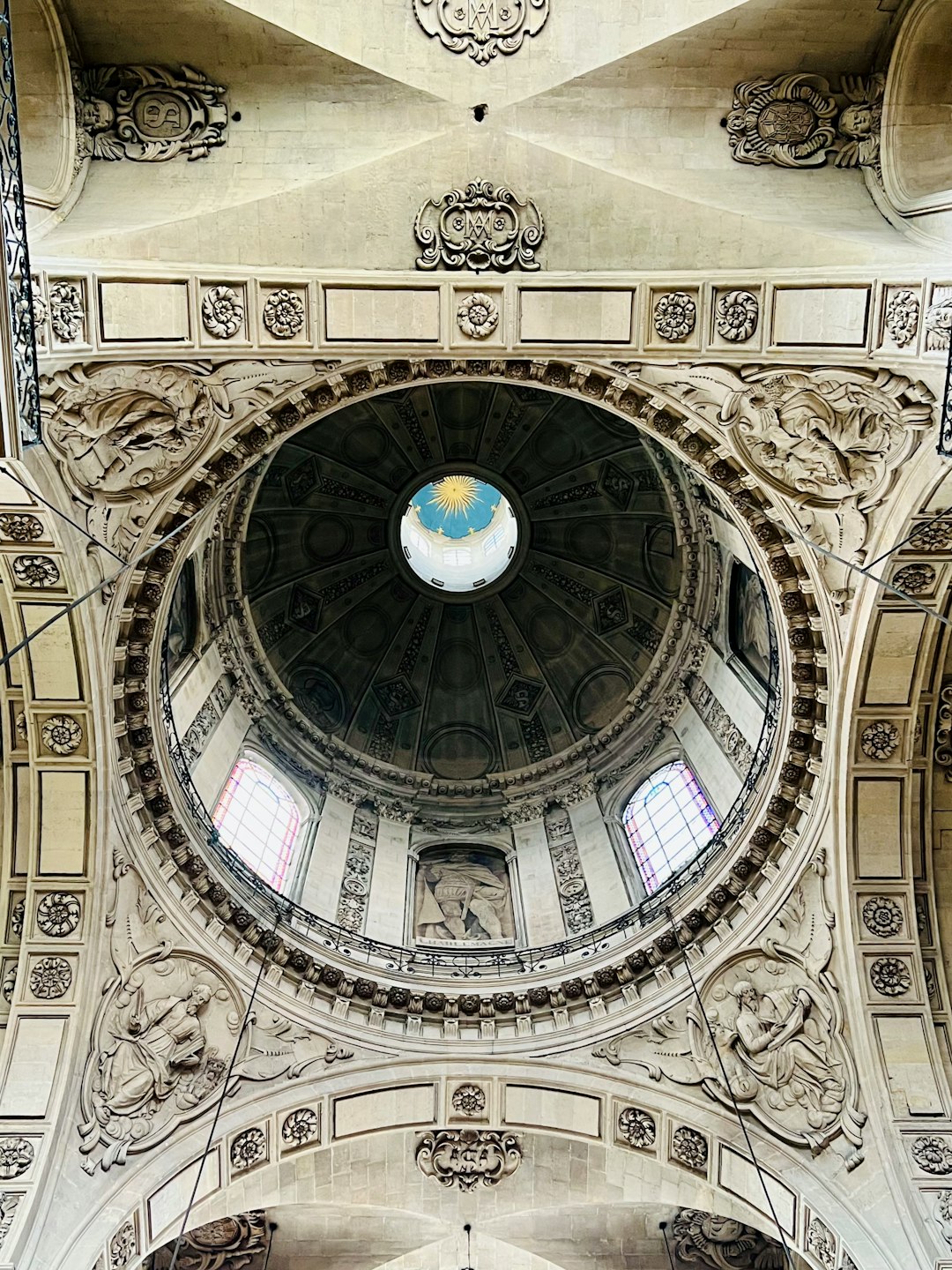 Beautiful view looking up at the domed ceiling at Elise Saint-Paul-Saint-Louis, a beautiful church on Rue Saint-Antoine in the 4th arrondissement of Paris, France. Per Wikipedia, this church was constructed between 1627 - 1641 on the orders of Louis XIII of France. It was the first church to be constructed not in the Gothic style but in the new Baroque style of the Jesuits.